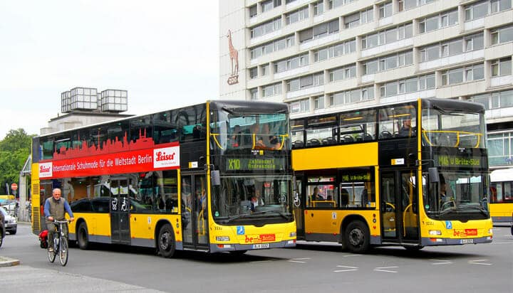 Picture of two yellow buses on the road in Berlin, Germany.