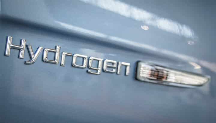 Picture of a close-up of a car with hydrogen written on it