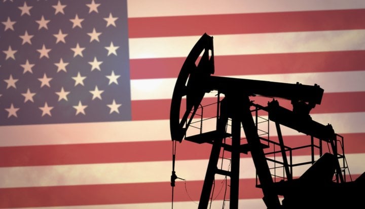 US flag and oil derrick