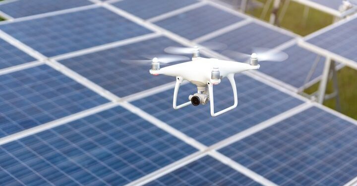 Drone flying over solar panels