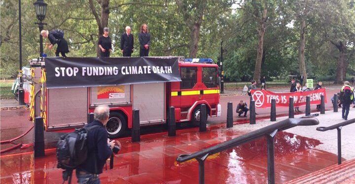 Extinction Rebellion climate activists spray fake blood outside Treasury